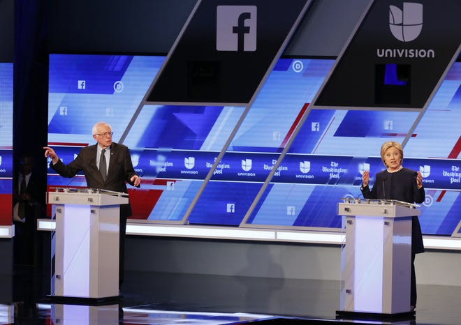 Democratic presidential candidates, Hillary Clinton and Sen. Bernie Sanders, I-Vt, speak at the Univision, Washington Post Democratic presidential debate at Miami-Dade College on Wednesday in Miami. WILFREDO LEE/THE ASSOCIATED PRESS