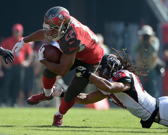 Buccaneers running back Doug Martin (22) is staying in Tampa after re-signing for five seasons, the team announced Wednesday. The top player at his position on the market, Martin will get more than $35 million, with $15 million guaranteed.
