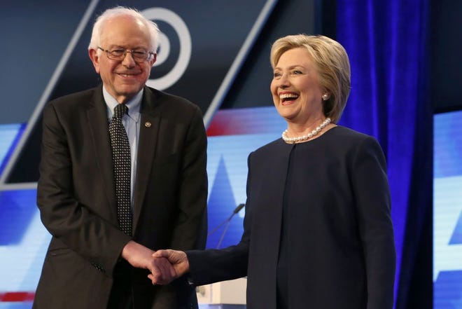 Democratic presidential candidates, Hillary Clinton and Sen. Bernie Sanders, I-Vt, shake hands before the start of the Univision, Washington Post Democratic presidential debate at Miami-Dade College on Wednesday, in Miami, Fla. AP Photo/Wilfredo Lee