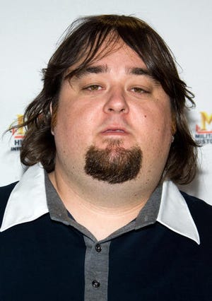 In this May 5, 2010 file photo, Chumlee of the reality cable TV show "Pawn Stars," whose given name is Austin Lee Russell, arrives at A&E Television Network's Upfront in New York. Russell was being held in a Las Vegas jail late Wednesday, March 9, 2016, following his arrest on weapon and multiple drug charges, after officers serving a warrant at his home in a sexual assault investigation found methamphetamine, marijuana and at least one gun. (AP Photo/Charles Sykes, File)