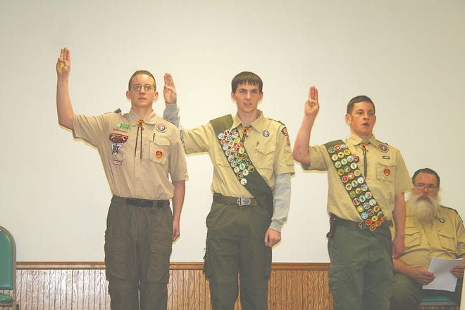 Kyle Hengst, Chris Bowman and Tim Milback make the Eagle Scout Promise Feb. 27 at Kauffman Ruritan Club. Seated is Daniel McGlothin, Scoutmaster of Boy Scout Troop 413.