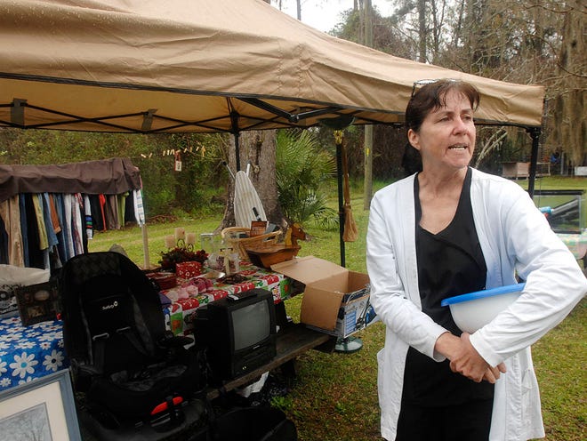 Debbie Underwood is pictured at her sale site north of Brunswick beside U.S. 341 at last year's Peaches to the Beaches Yard Sale. The Underwoods have a combined family reunion-yard sale there each year.