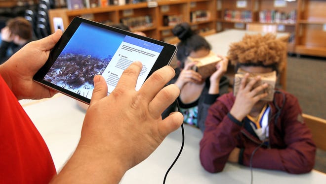Mount Holly Middle School teacher Grayson Bedenbaugh selects a location for students in his class to see using their viewers with the Google Expeditions virtual reality program. Mount Holly Middle is one of about 100 schools nationwide to participate in Google's Expeditions virtual reality learning initiative. (John Clark/The Gazette)