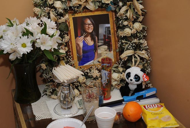 A tribute to Carlene Phouthavong in the family living room. It's a Cambodian tradition of keeping a shrine to the person who has passed and bring food to it every day.