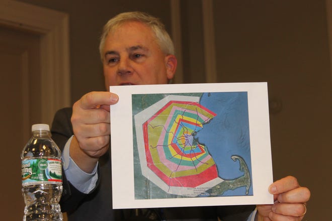 MBTA general manager Frank DePaola holds up a map showing the commuter rail fare zones and their relationships to North and South Stations during a meeting last week. Wicked Local photo/Matt Robare