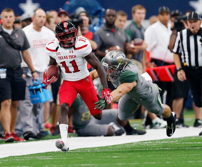 Tech's Jakeem Grant runs down the sidelines pursued by Baylor's Kendall Ehrlich in the first half. Texas Tech played Baylor University Saturday, Oct. 3, 2015, at AT&T Stadium in Arlington, Texas. (Mark Rogers/AJ Media)