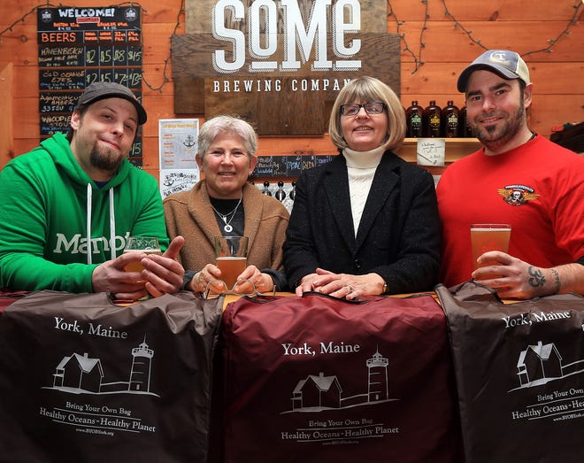 From left, Dave Rowland, co-owner and head brewer of SoMe Brewing Co., Victoria Simon, chairwoman of Bring Your Own Bags-York committee, Chris Hartwell, committee member, and Jeff Goodno, Surfrider Foundation Maine Chapter chairman, celebrate at the kick-off party for the new bag ordinance in York on Friday night. Rowland and Goodno, who is the lead brewer at Tributary Brewing Co. in Kittery, collaborated on a new beer for the event, "Old Orange Eyes."

Ioanna Raptis/Seacoastonline