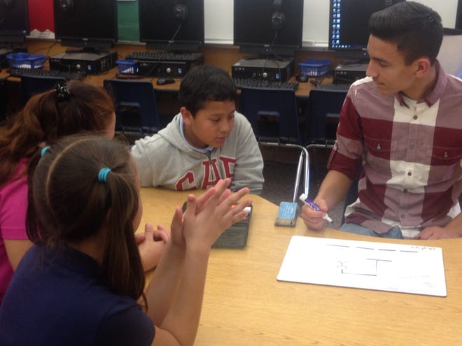 Barstow High School junior Andrew Espinoza plays a round of “Hangman” with a group of students from Crestline Elementary School’s Afterschool Intervention Program. Espinoza created a program called STAMP — Student Tutoring and Mentoring Program. As part of the program, BHS students visit Crestline Elementary School on Tuesdays and Thursdays to volunteer their time to tutor and mentor students in the Afterschool Intervention Program. Jose Quintero, Desert Dispatch
