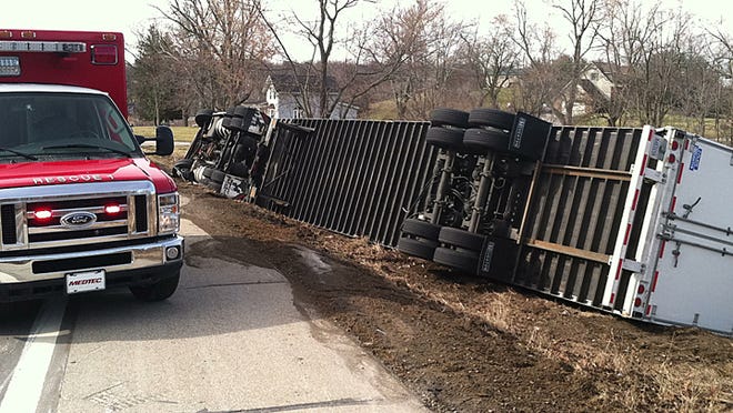 Emergency crews are seen at a semi truck that rolled over Friday on U.S. 12.