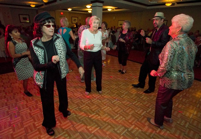 From left, Kay Shelby,Margaret Lovingfoss, Pablo Reyes and Donna Etzel enjoy dancing during the show at the Hilton Garden Inn in Lakeland.
