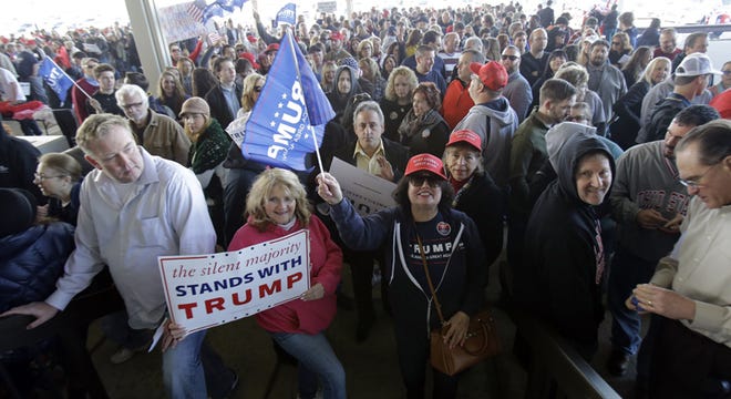 Trump supporters line up to enter the venue to hear Republican presidential candidate Donald Trump, speak at a campaign rally at the I-X Center Saturday, March 12, 2016, in Cleveland. (AP Photo/Tony Dejak)
