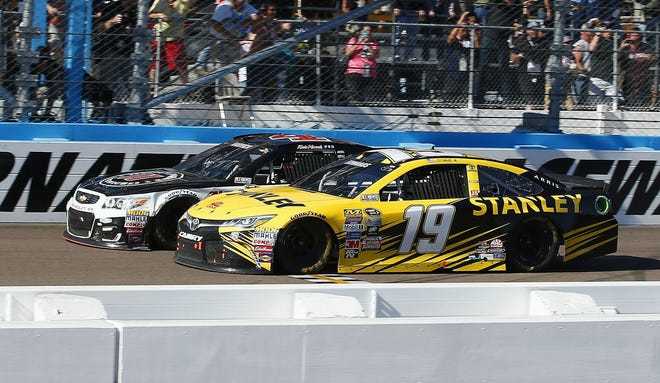 Kevin Harvick, left, has just enough to beat Carl Edwards, right, at the finish line during a NASCAR Sprint Cup Series auto race at Phoenix International Raceway on Sunday in Avondale, Ariz. Associated Press/Ross D. Franklin