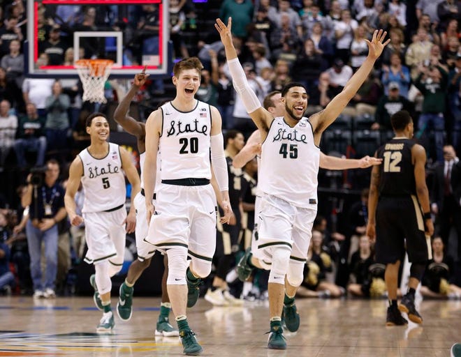 Michigan State players celebrate after an NCAA college basketball game against Purdue in the finals at the Big Ten Conference tournament, Sunday, March 13, 2016, in Indianapolis. Michigan State won 66-62. (AP Photo/AJ Mast)