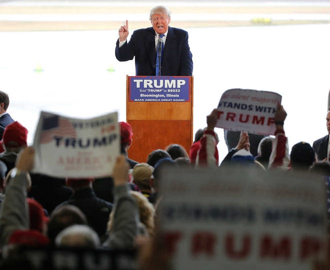 Republican presidential candidate Donald Trump addresses the crowd during a rally Sunday, March 13, 2016, in Bloomington, Ill. (AP Photo/Charles Rex Arbogast)