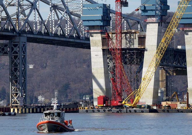 A Coast Guard boat passes near the site of a fatal collision in the water underneath the Tappan Zee Bridge in Tarrytown, N.Y., Saturday, March 12, 2016.  A tugboat crashed into a barge on the Hudson River north of New York City early Saturday killing at least one crew member and leaving two still missing. (AP Photo/Seth Wenig)