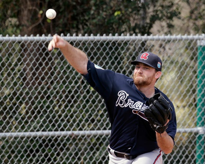 Atlanta Braves pitcher Chris Withrow throws during a spring training baseball workout, Sunday, Feb. 21, 2016, in Kissimmee, Fla. (AP Photo/John Raoux)