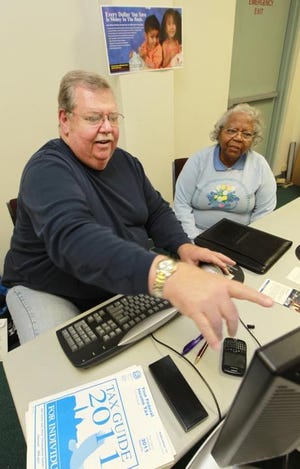(Photo by Mike Hensdill/The Gaston Gazette) In this file photo, volunteer Lee Young and greeter Oda Haygood talk about taxes as they wait for people to take advantage of the free tax preparation services offered in 2012. Seven complaints for tax-related identity theft were filed in 2015.