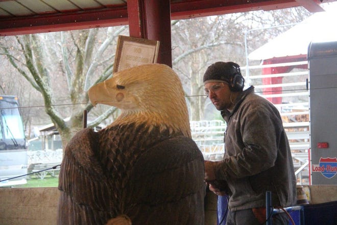 The NORCAL Invitational Chainsaw Carving Championships returned to the Expo this year. A carver, in photo, works on creating a eagle. Daily News Photo/ Bill Choy