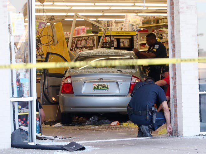 Authorities work the scene of an accident where a car went through the front of the Dollar General located in the Northwood Crossings shopping center on McFarland Boulevard in Northport Monday, Mar. 14, 2016. Three people were injured in the incident. The cause is under investigation.