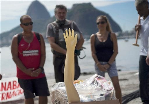 ctivists protest next to a plastic arm, displayed on the sands of Botafogo beach, symbolizing the burial of Guanabara Bay during a demonstration against the pollution of the waters, in Rio de Janeiro, Brazil, Saturday, Feb. 27, 2016. Activists alleging that decades of neglect and authorities' repeated failure to make good on cleanup promises have effectively killed one of Rio de Janeiro's most iconic waterways where Olympic sailing competitions are to be held.