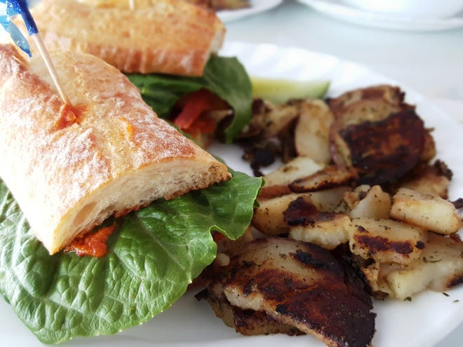 Shrimp Po Boy sandwich with home fries. NEWS-JOURNAL/GODWIN KELLY