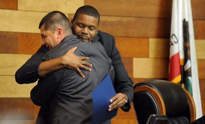 The mayoral race is bound to be contentious between incumbent Anthony Silva, foreground, and City Councilman Michael Tubbs. But they have had their moments, including this hug after swearing-in ceremonies on Jan. 8, 2013. RECORD FILE 2013
