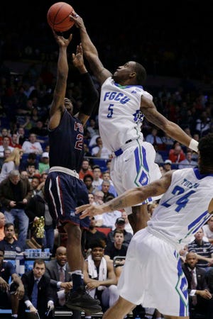 Florida Gulf Coast's Zach Johnson blocks a shot by Fairleigh Dickinson's Darian Anderson, right, in the second half of a First Four game of the NCAA Tournament on Tuesday in Dayton, Ohio. (AP Photo/John Minchillo)