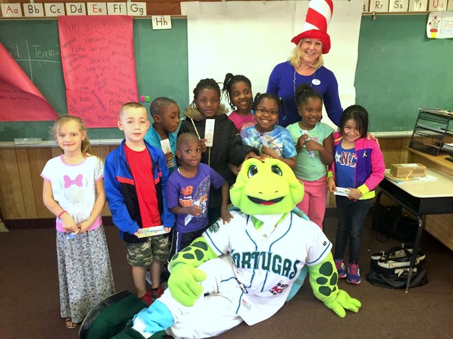 To celebrate Dr. Seuss' birthday on March 2, the Volusia Flagler Family YMCA family centers and YREADS! Program at Turie T. Elementary School participated in Read Across America Day. Volusia Flagler Family YMCA President and CEO Teresa Rand, back right, and Sheldon the Daytona Tortugas mascot read "Oh The Places You'll Go" to the students. Guest readers also visited YMCA family centers throughout Volusia County to share their favorite Dr. Seuss book and their passion for reading with the afterschool program participants.