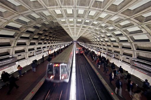 Metro trains arrive in the Gallery Place-Chinatown Metro station Tuesday, March 15, 2016 in Washington. The head of the rail system that serves the nation's capital and its Virginia and Maryland suburbs says the system will shut down for a full day Wednesday after a fire near one of the system's tunnels. (AP Photo/Alex Brandon)