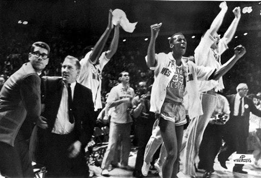 FILE - In this March 19, 1966, file photo, Texas Western basketball coach Don Haskins, second from left, and players celebrate after winning the NCAA basketball championship in College Park, Md. Fifty years ago, Texas Western started five blacks–Willie Worsley, Orsten Artis , Bobby Joe Hill, David "Big Daddy" Lattin and Harry Flournoy–against Kentucky in the NCAA championship game. Today, after reading historical recaps and watching movies, people tend to think it was an immediate watershed moment in sports and civil rights. It wasn't. (AP Photo/File)