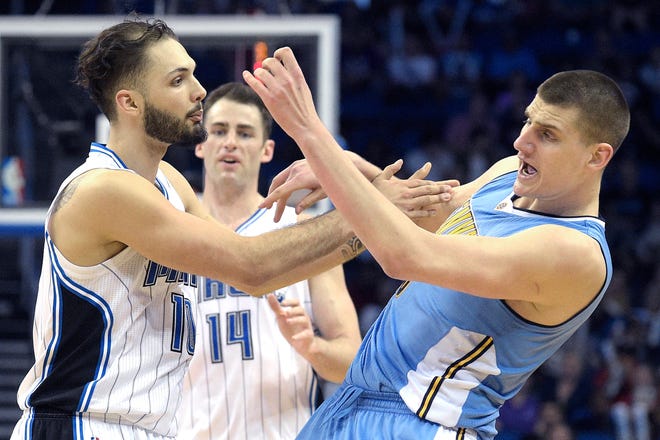 Orlando Magic guard Evan Fournier, left, shoves Denver Nuggets center Nikola Jokic, right, in retaliation after being fouled by Jokic during the second half in Orlando on Tuesday. Fournier received a technical foul for the incident.