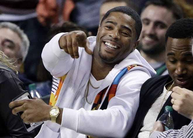 Patriots cornerback Malcolm Butler (left) laughs while sitting courtside with teammate Dion Lewis at a February Celtics/Bucks game at TD Garden.
