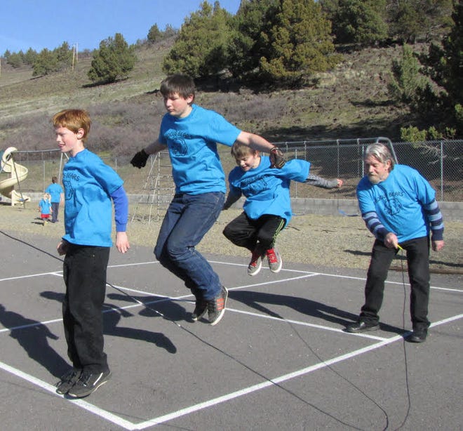 ​Russell Nussbaum, Joe Evans and Charley Evans jump together at last year's Bogus School Jump Rope For Heart event while (former superintendent) Fred Ehmke turns the rope.