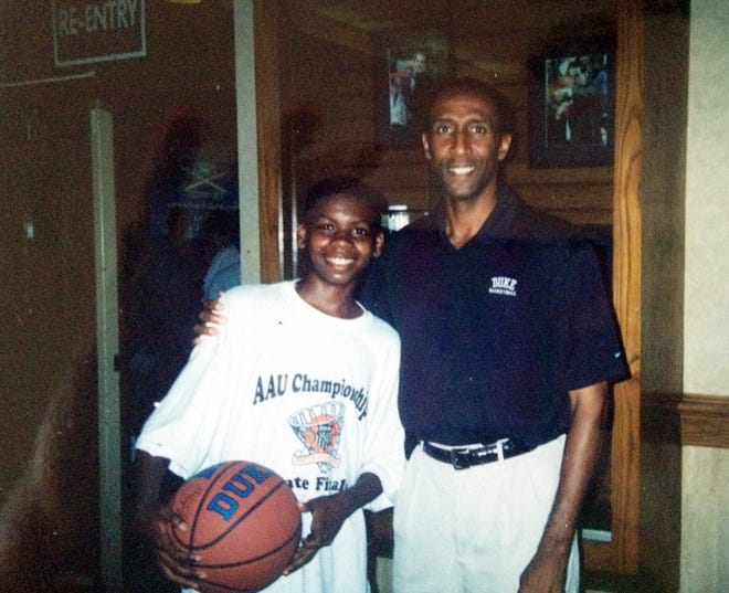 A young Chris Flemmings with former Duke assistant Johnny Dawkins is seen in the undated contributed photo.