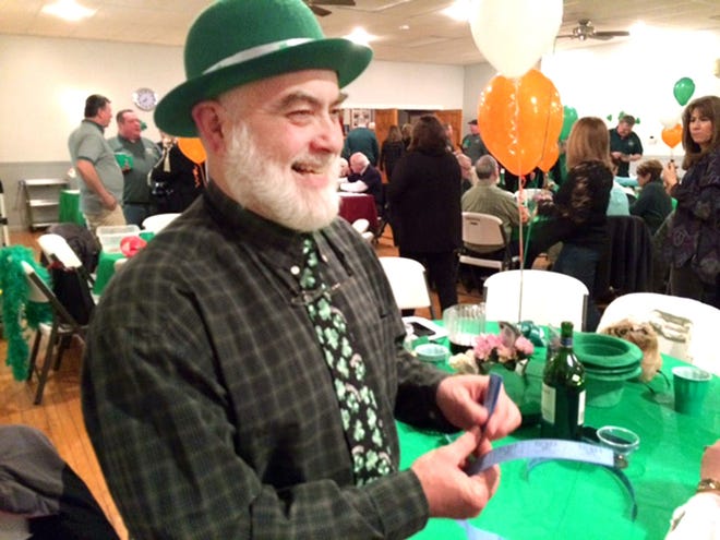 Cletus O'Mahoney, a member of the Ancient Order of Hibernians Newtown, Division 2, buys raffle tickets at the AOH Celtic Kilt Night fundraiser on March 5.