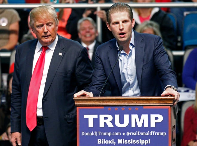 FILE - In this Jan. 2, 2016 file photo, Republican presidential candidate Donald Trump, left, listens as his son Eric Trump speaks during a rally in Biloxi, Miss. A law enforcement official says New York City police and the FBI are investigating a threatening letter sent to the Manhattan apartment of Eric Trump. The official says the envelope sent to Eric Trump's apartment on Thursday, March 17, 2016 contained a suspicious white powder and a threatening letter. There were no injuries and the official said preliminary tests indicated that the white substance was not hazardous. (AP Photo/Rogelio V. Solis)