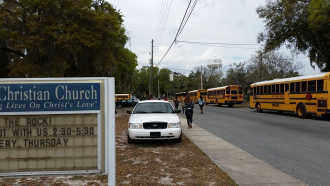 Police vehicles surrounded the Leesburg Christian Church on Friday to deter any trouble after a fight involving Leesburg High School students as well as grown-ups spilled into the church parking lot on Wednesday.