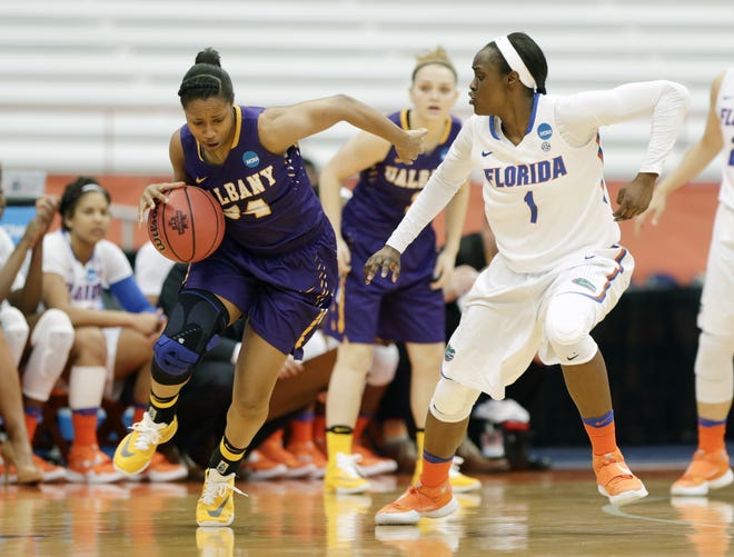 Albany's Cassandra Edwards (34) drives against Florida's Ronni Williams during the first half Friday in Syracuse, New York. ASSOCIATED PRESS/MIKE GROLL