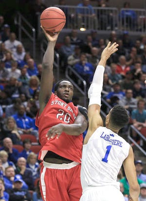 Stony Brook's Jameel Warney (left) shoots over Kentucky's Skal Labissiere during Thursday's NCAA Tournament game in Des Moines, Iowa. 

AP Photo/Nati Harnik