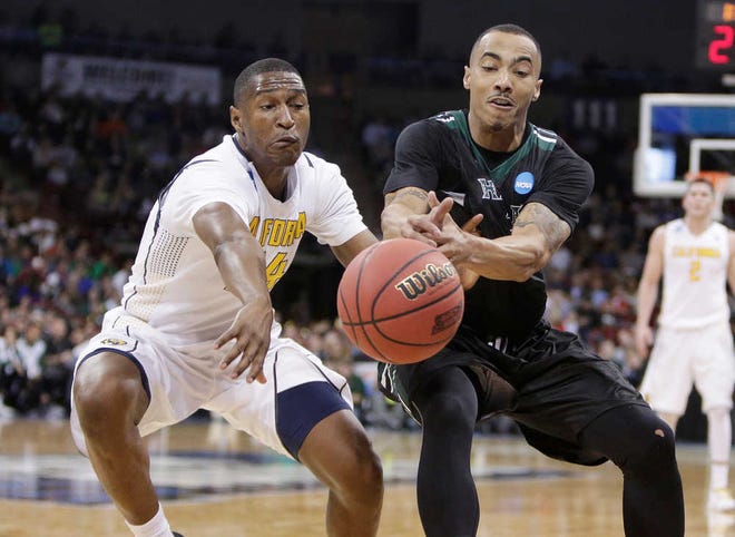 California guard Jordan Mathews, left, and Hawaii guard Quincy Smith go after a loose ball during the second half of their first round game in the NCAA Tournament on Friday in Spokane, Wash. Hawaii won 77-66. (AP Photo/Young Kwak)