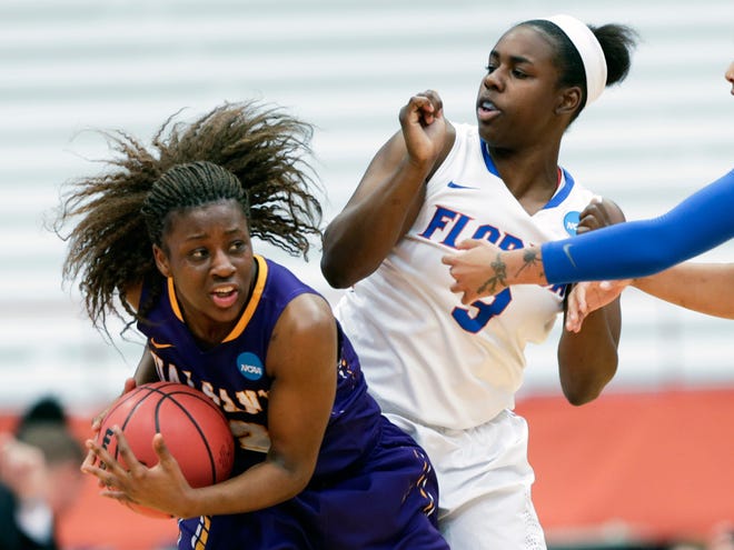 Albany guard Zakiya Saunders, left, keeps the ball away from Florida guard January Miller (3) during the first half of a first-round game at the Women's NCAA Tournament on Friday in Syracuse, N.Y.