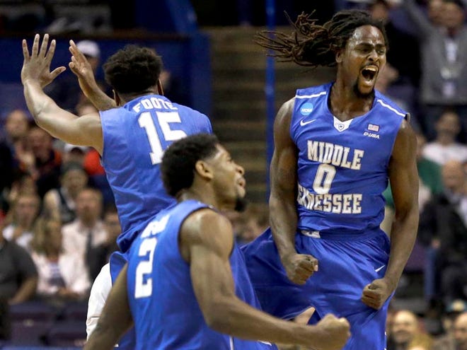Middle Tennessee's Darnell Harris (0), Perrin Buford (2) and Aldonis Foote (15) celebrate during the first half in a first-round men's college basketball game against Michigan State in the NCAA tournament, Friday, March 18, 2016, in St. Louis. (AP Photo/Jeff Roberson)