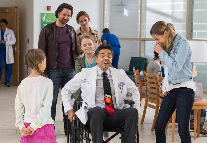 This image released by Sony Pictures shows, Martin Henderson, back left, Jennifer Garner, back right, and from foreground right, Brighton Sharbino, Kylie Rogers pushing Eugenio Derbez and Courtney Fansler in a scene from 'Miracles from Heaven.'

Chuck Zlotnick, Sony Pictures via AP
