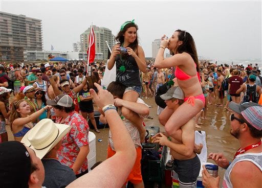 exas Tech students Kaitlyn Braswell, left, and Brylie Schafer drink beer while celebrating spring break on the beach Thursday, March 17, 2016, at South Padre Island, Texas.