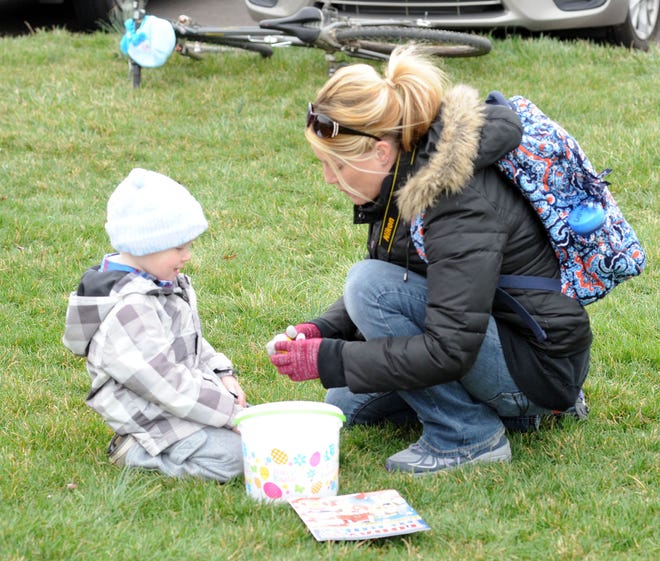 Shawn Holmes, 3, and his mother, Rebecca Holmes, of Churchville, open eggs found during an Easter egg hunt sponsored by the Feasterville Business Association and the Friends of the Lower Southampton Library on Saturday March 19, 2016, at Russell Elliot Park in Lower Southampton.