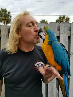 Mike Mularz just couldn't stop kissing his beloved Spyke Saturday after an anonymous call led him to the macaw he has raised for 22 years. Photo provided by Mike Mularz