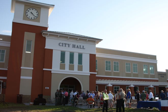 Visitors line up at the entrance to the new Palm Coast City Hall during the grand opening ceremony. The new facility was one of the items highlighted in the city's progress report to residents. NEWS-TRIBUNE FILE/LOLA GOMEZ