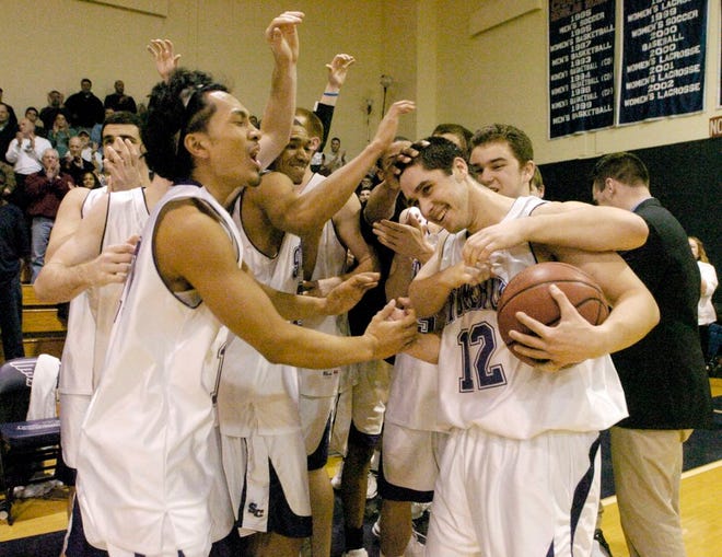 Stonehill players, including present-day coach Chris Kraus, celebrate their victory over UMass-Lowell on March 22, 2006, a victory that earned the team a berth in the Division II Elite Eight. Below, Stonehill's Mike Lauricella tries to fight off the pressure of Adelphi's Kimani Blaize during a 69-54 win in a Division II Northeast Regional semifinal in Easton.