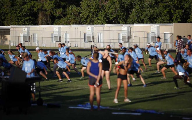 DARON.DEAN@STAUGUSTINE.COM Relocatables can be seen at Nease High School as band members practice on the athletic field Friday afternoon, October 16, 2015. About 600 students are learning in relocatables at the school.
