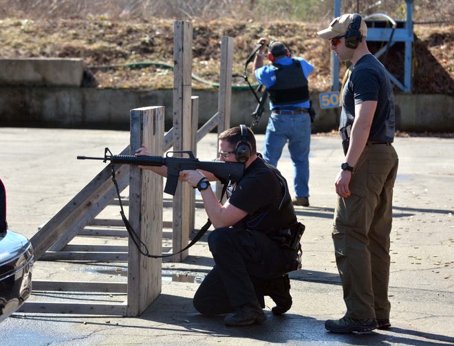 State Trooper First Class Tyler Charette, right, a firearms instructor, looks on as Trooper John Baisley from Troop D in Danielson fires his weapon Thursday morning at the Firearms Training Unit in Simsbury. The state is looking for land in Eastern Connecticut to build a new training facility because the one in Simsbury floods frequently. 

Aaron Flaum/ NowichBulletin.com